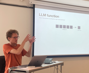 Photo of David Grellscheid explaining a bit about how LLMs generate text.